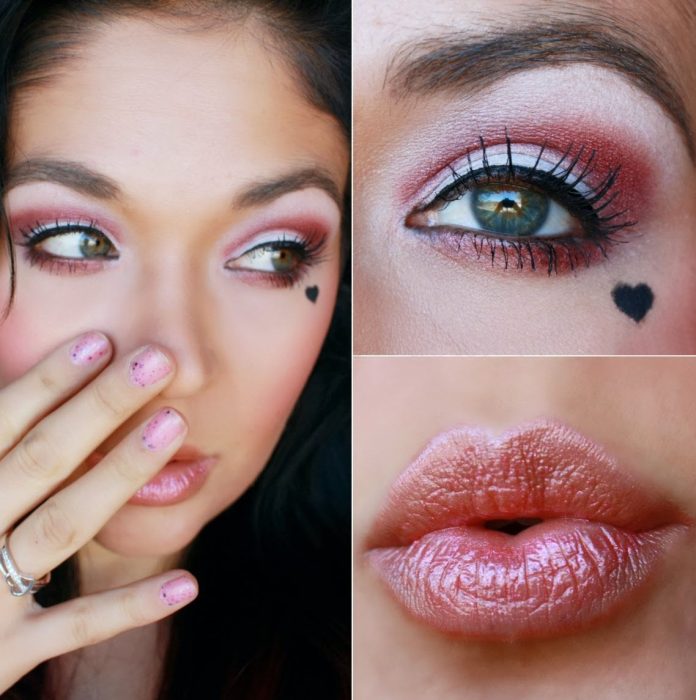 chica con maquillaje de san valentin y corazón rojo