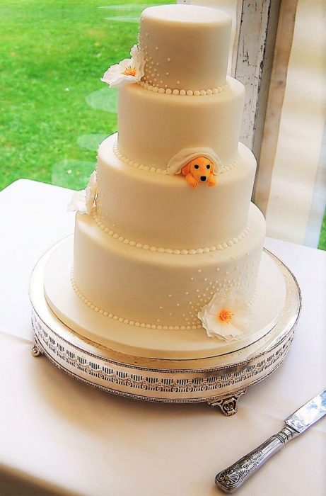 Pastel de bodas que incluye a una pequeña mascota 