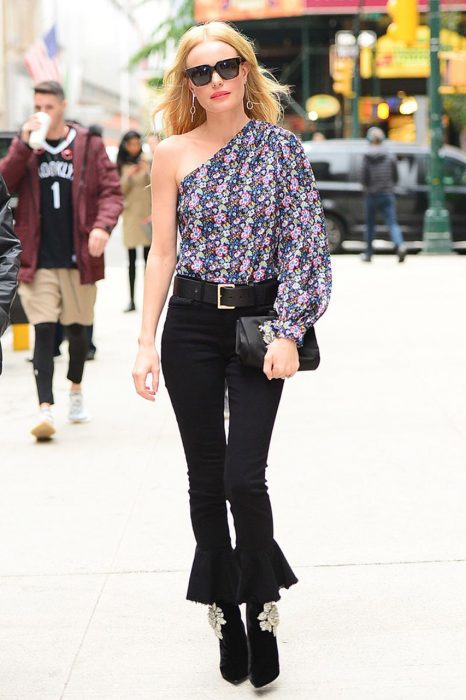 Olivia palermo usando pantalones negros blusa sin hombros y cinturón negro 