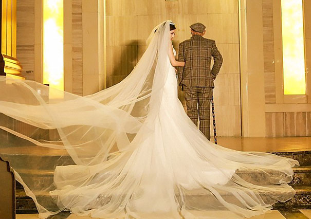 Chica vestida de novia posado junto a su abuelo