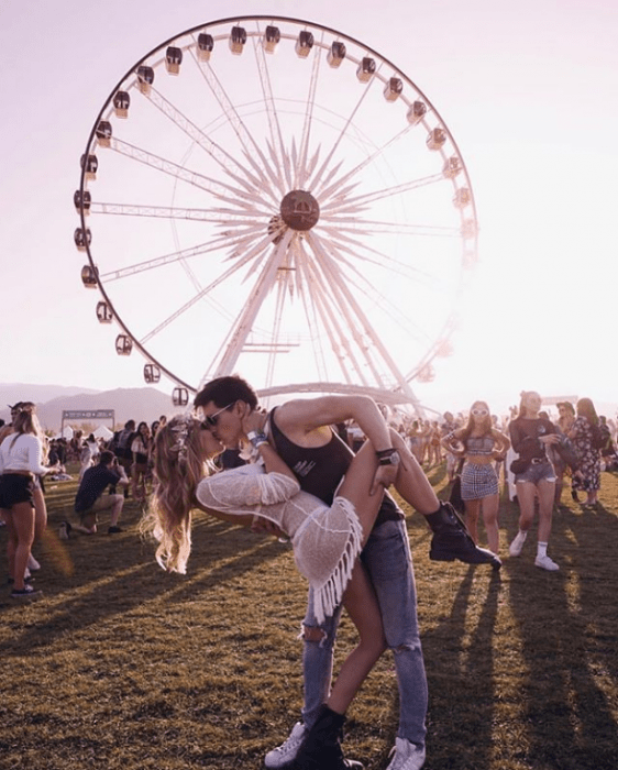 pareja de novios besándose frente a la rueda de la fortuna