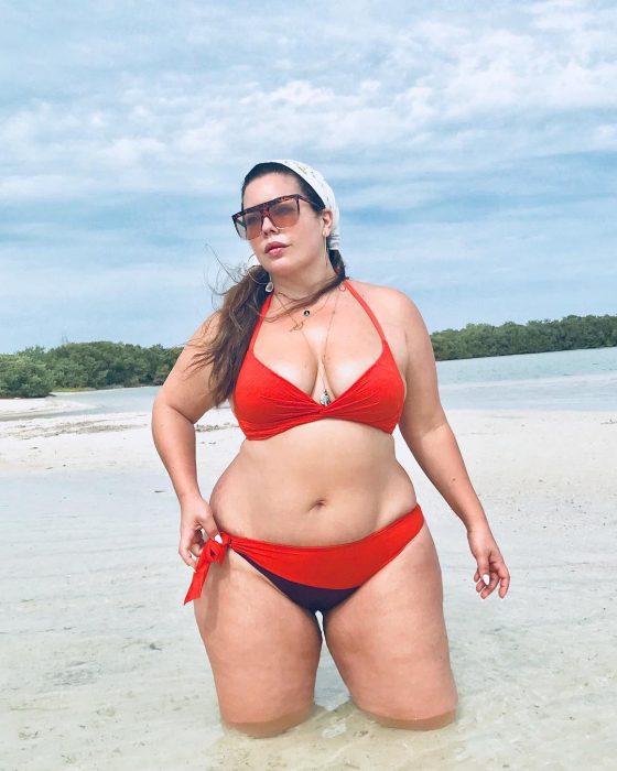 Modelo plus size fluvia Lacerda usando un atuendo de traje de baño rojo 