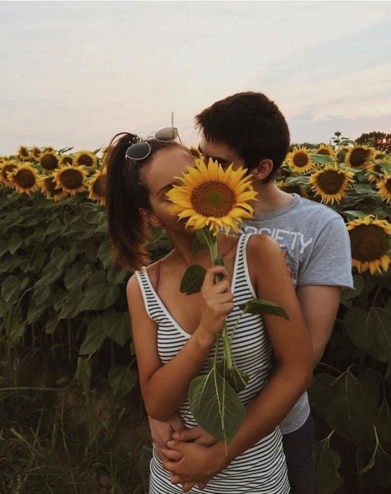 pareja de novios en un campo de flores