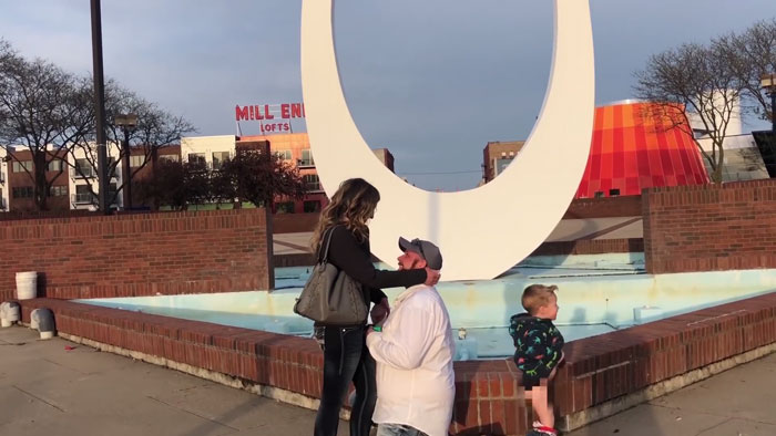 Niño haciendo pipi mientras sus padres se besan en una propuesta de matrimonio 