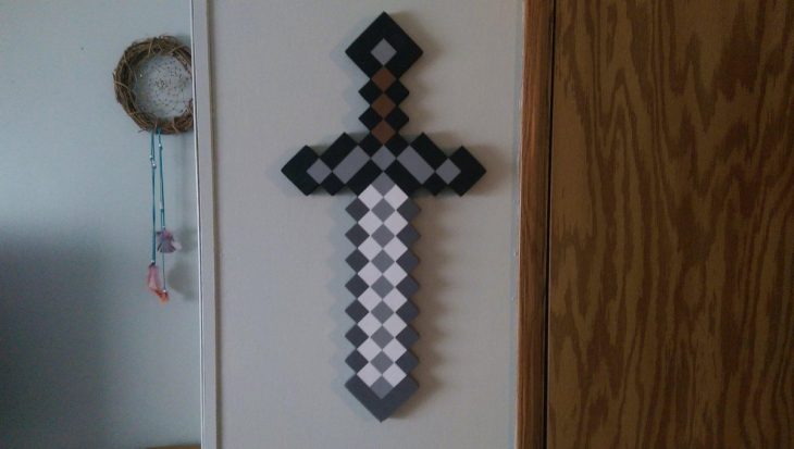 Espada de Minecraft colgada en la pared como si fuera una cruz