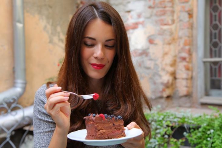 chica comiendo pastel de chocolate