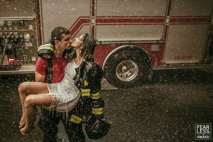 pareja hombre mujer bombero entre la lluvia 