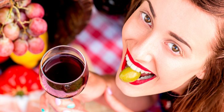 chica comiendo aceitunas y vino