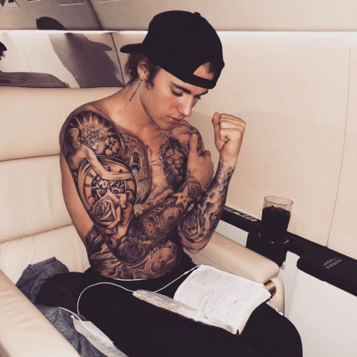 Justin Bieber enseñando sus tatuajes