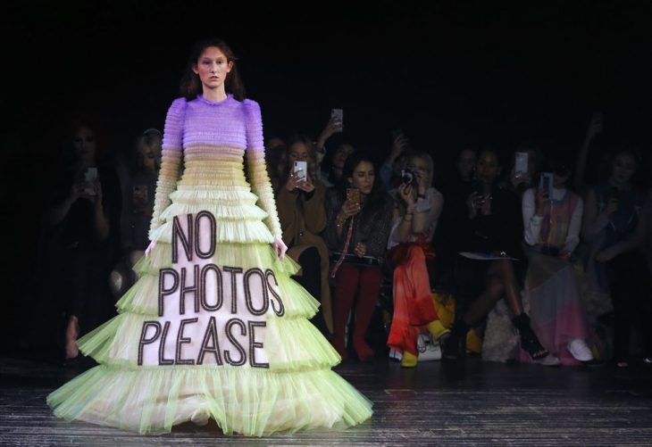 mujer pasarela de modas con vestido color morado blanco letras 