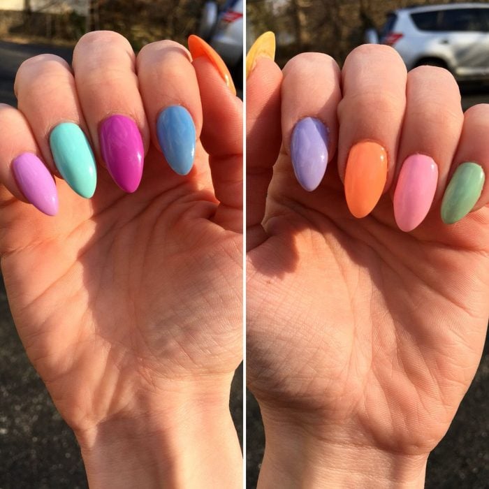 manos de mujer uñas de colores arcoiris 