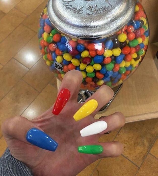 manos de mujer con uñas de colores 