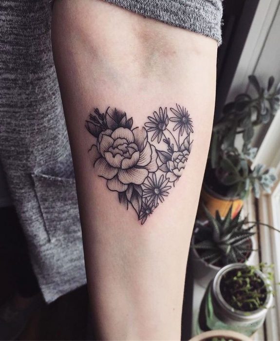 Mujer con tatuaje de flor en el brazo