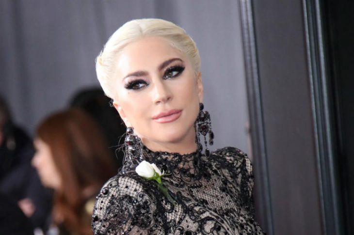 Lady Gaga modelando en la alfombra roja con vestido de encaje en negro