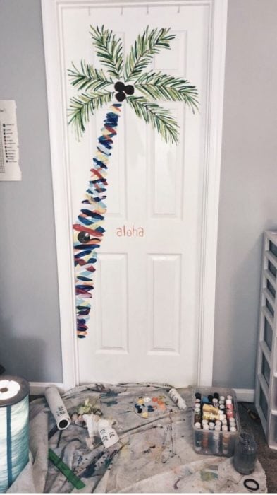Door of a room decorated with a palm tree drawn by hand 