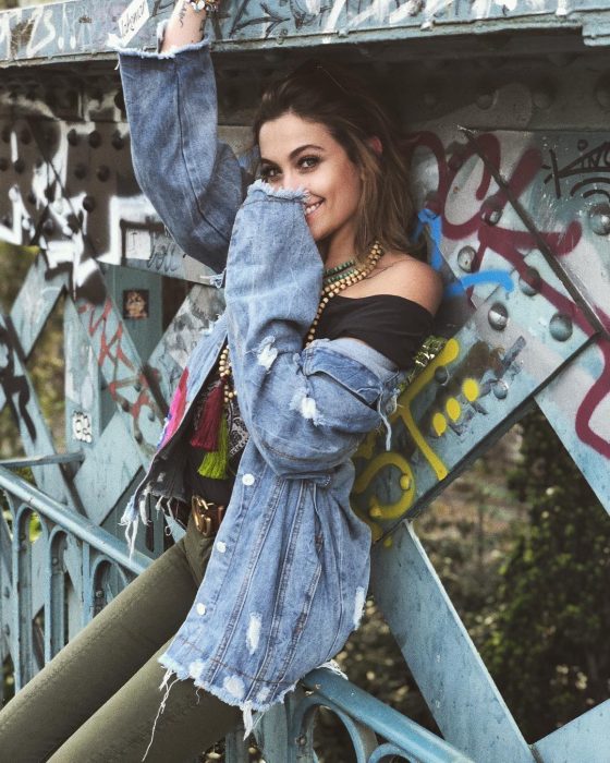 Paris Jackson, daughter of singer and pop king, Michael Jackson, wearing a worn denim jacket, oversized trend