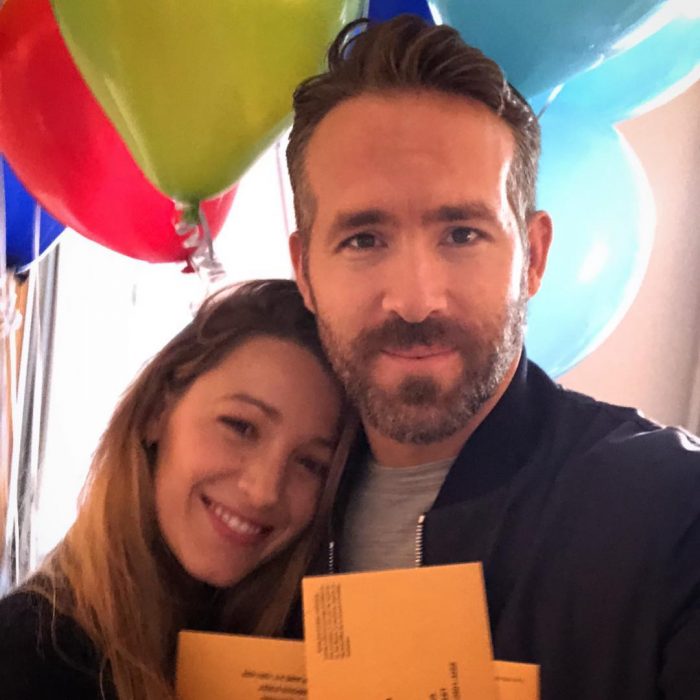 Blake Lively y Ryan Reynolds abrazados mostrando sus globos y tarjetas de feliz cumpleaños