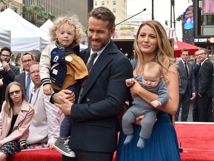 Blake Lively y Ryan Reynolds cargando a sus hijas Inez y James durante una alfombra roja