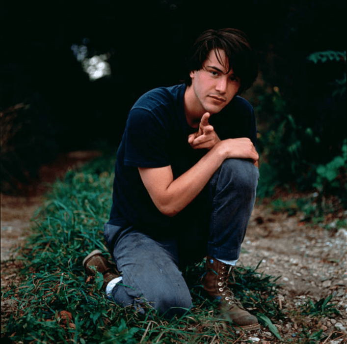 Actor Keany Reeves de joven; chico posando hincado para la cámara