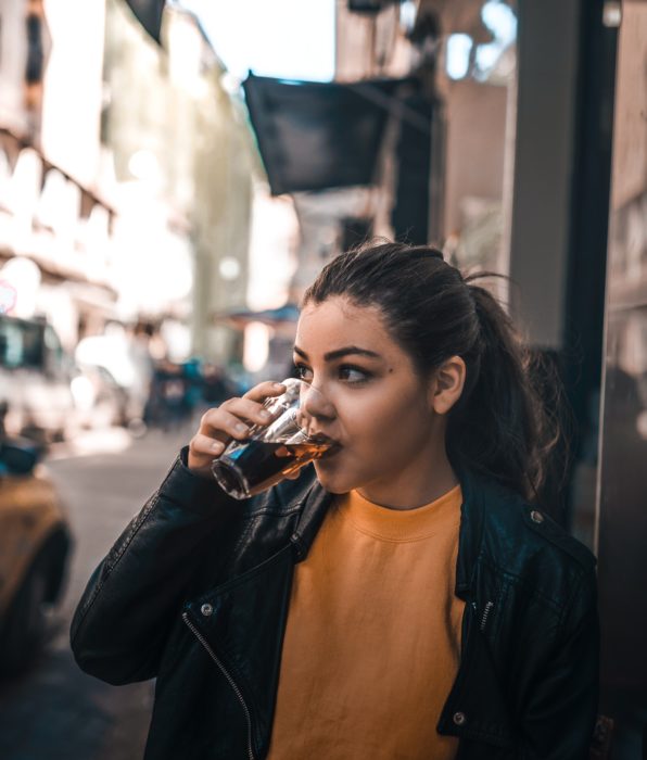 Chica tomando refresco en un vaso