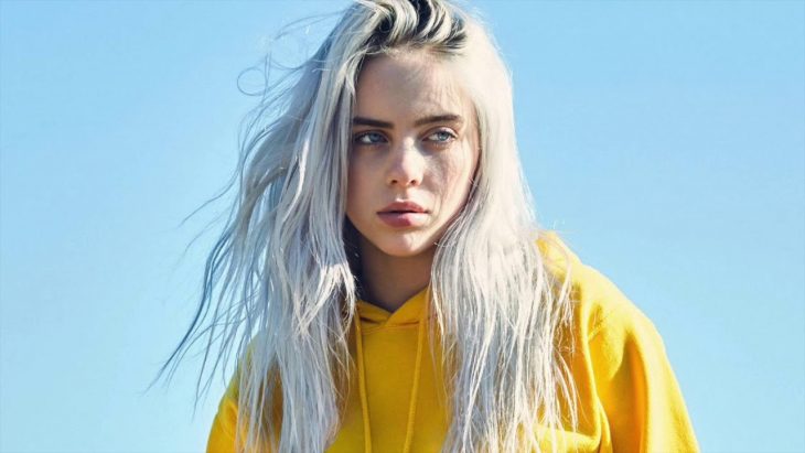 Billie Eilish rubia y con ropa amarilla