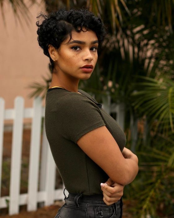 Chica afroamericana con pecas, de cabello corto y chino