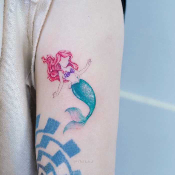 Chinese tattoo artist, Mini Lau;  Small and feminine tattoo with pastel colors of Ariel from The Little Mermaid