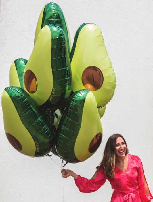 Fiesta temática de aguacate; chica sosteniendo globos