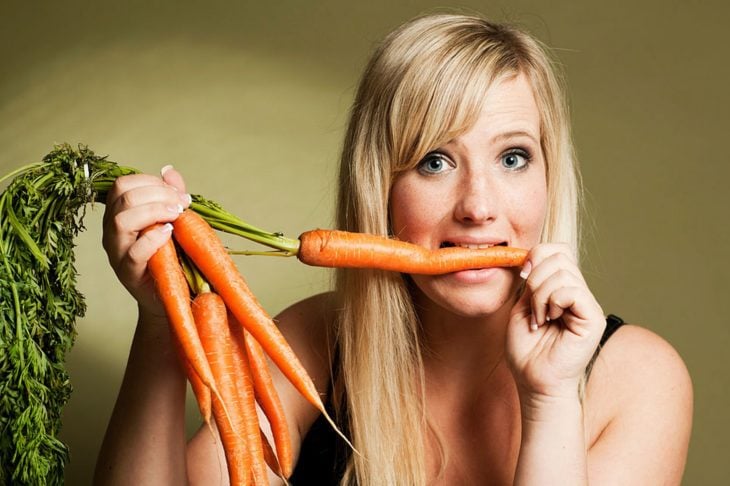 Mujer comiendo zanahorias