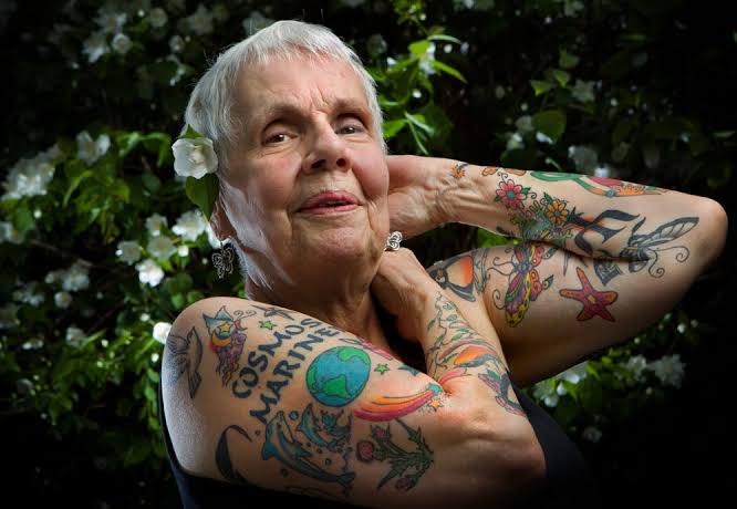 Abuela modelando sus brazos con tatuajes