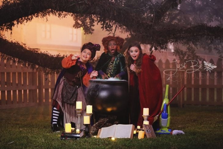Niñas disfrazadas de la película de brujas Hocus Pocus para Halloween; Winifred, Sarah y Mary Sanderson; caldero humeante
