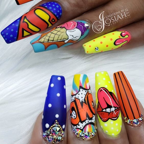 Manos de una chica con diseño de uñas pop art en colores con viñetas de superhéroes de cómics 
