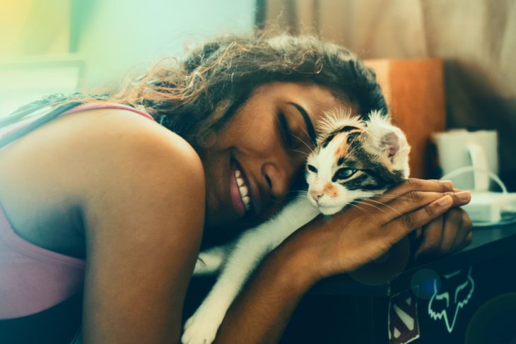 Mujer abrazando tiernamente a su gato