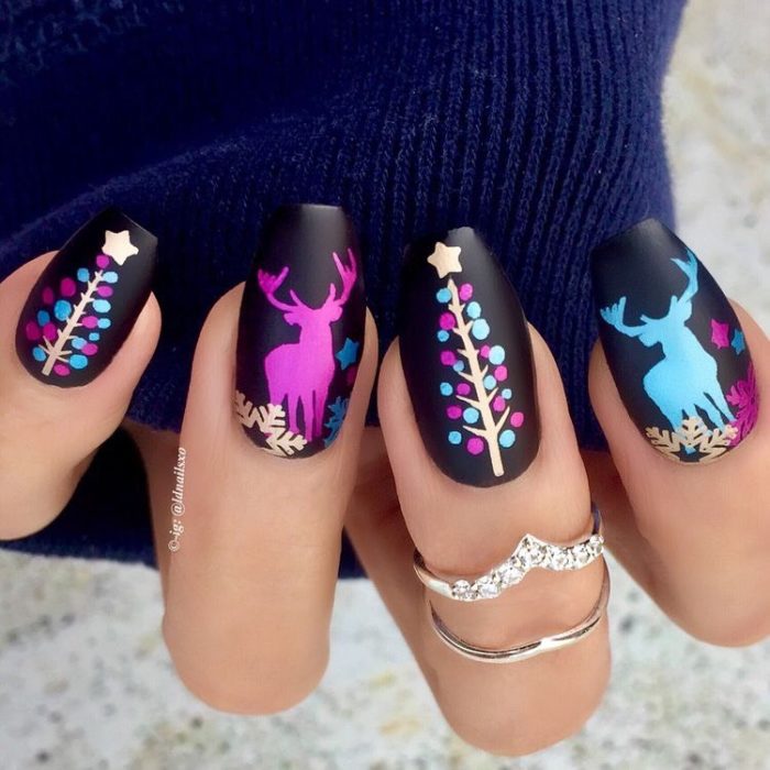 Manicura en negro decorada con renos en colores fluorescentes 