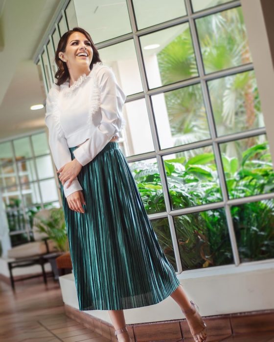 chica blusa blanca y falda metálica larga verde