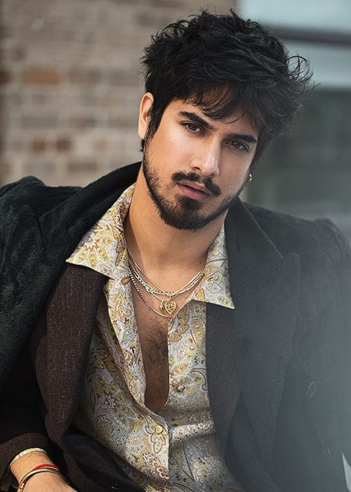 Avan Jogia modelando una chaqueta café