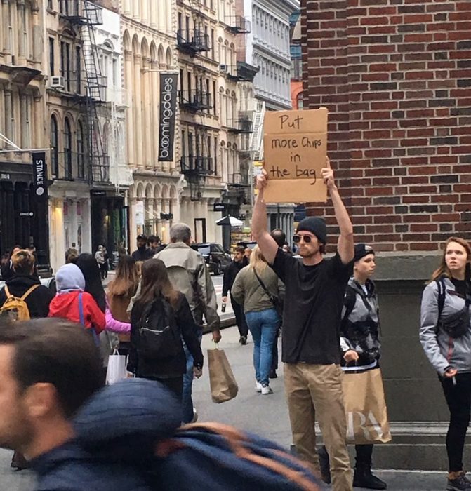 Chico con una pancarta protestando por el aire en las papitas fritas 