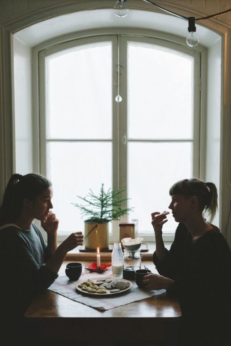 Amigas platicando mientras comen algo en alguna cafetería