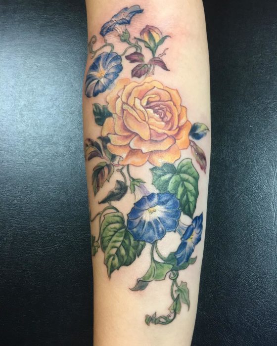 Tatuaje de rosa amarilla y flores azules