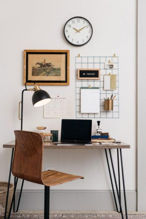 Área de escritorio con mesa y silla de madera con soporte de metal