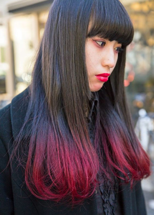 Chica asiática con cabello largo y puntas rojas