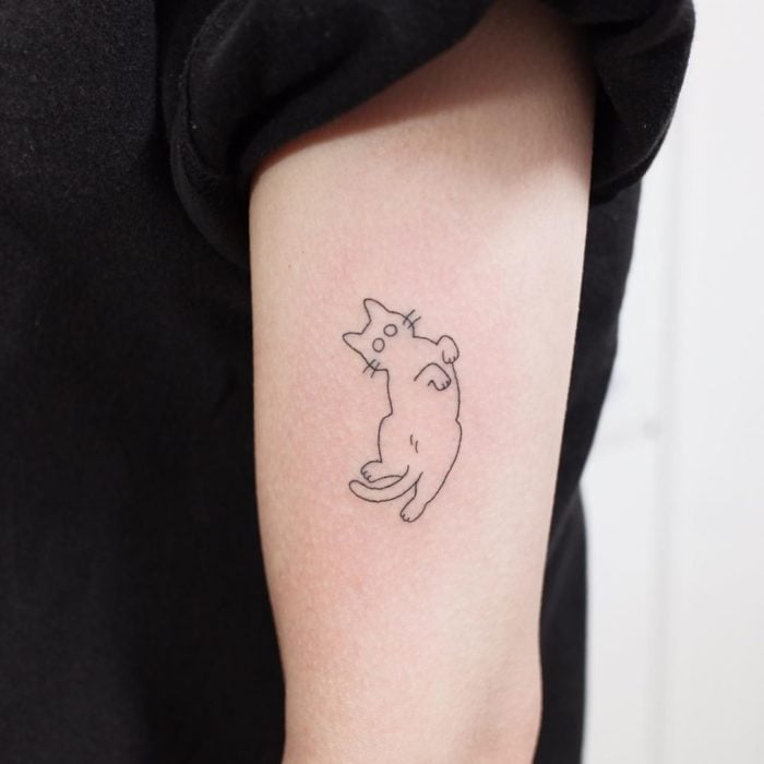 Tatuaje al estilo hand poke de la silueta de un gatito