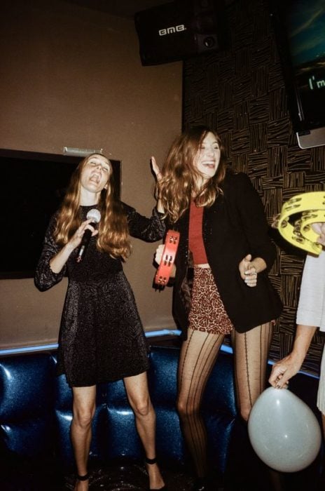 Chicas de fiesta cantando en un karaoke