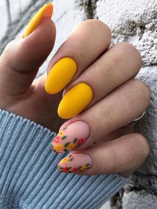 Manicura estilo francés con flores en dos uñas y en contraste con amarillo y naranja en guias verdes