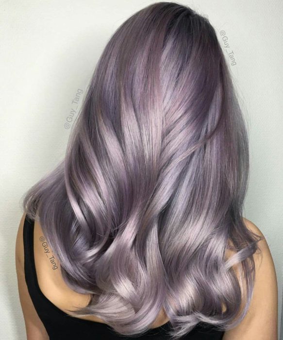 Chica con el cabello teñido de color morado con tintes de color gris 