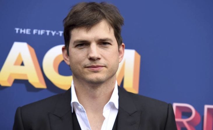 Ashton Kutcher llevando saco negro y camisa blanca mirando hacia el frente