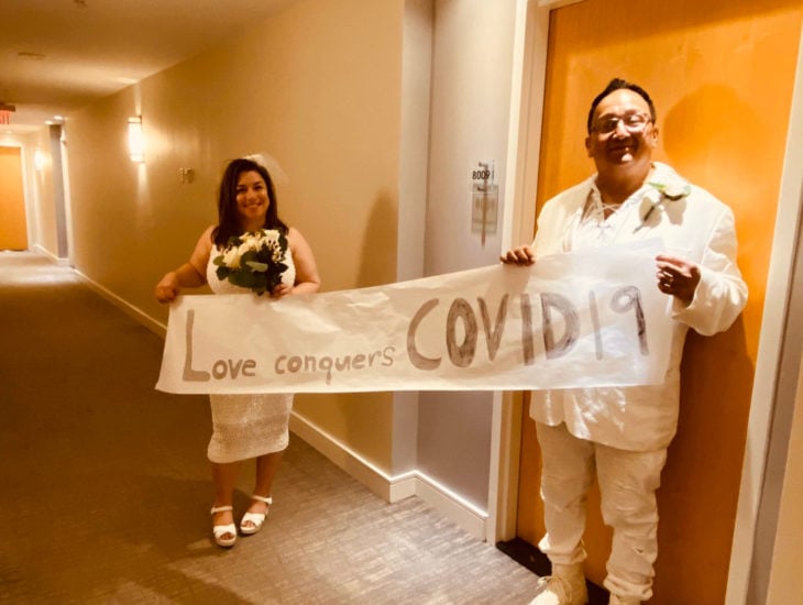 Parejas se casan en medio de cuarentena por coronavirus; esposos en pasillo con letrero
