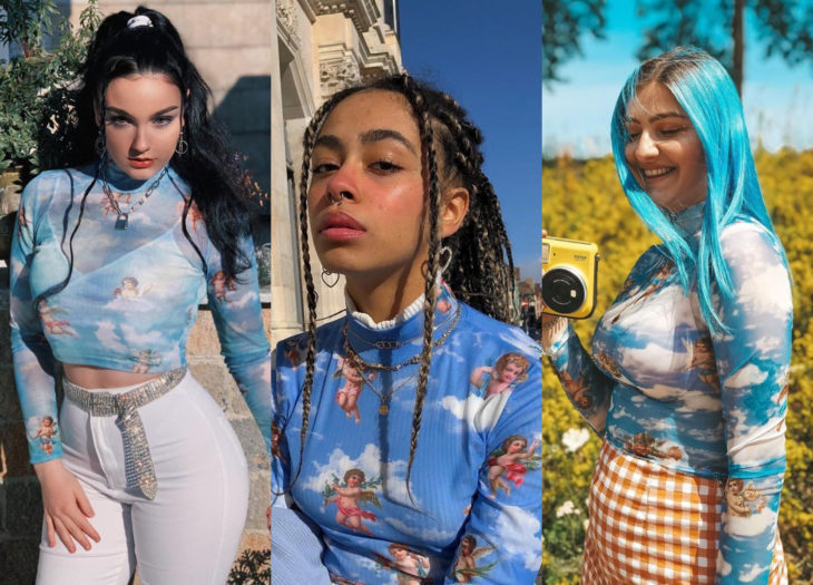 Ropa trendy, outfits; blusas azules con estampado de ángeles, choca de cabello negro peinado en una cola de caballo alta, mujer morena con trenzas africanas, mujer de cabello azulado pastel