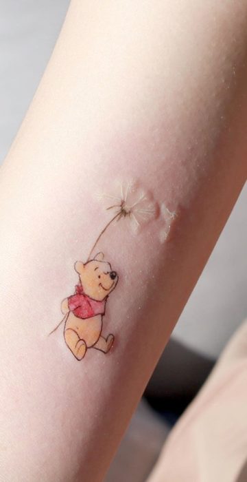 Tatuaje pequeño de Winnie Pooh en el brazo
