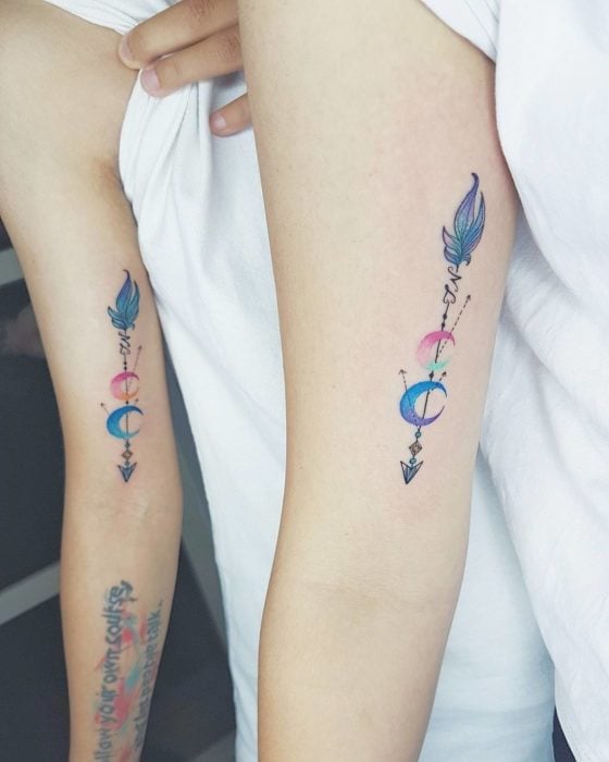 Tatuajes para compartir con tu mejor amiga con diseño de flechas de medias lunas u plumas en tonos azul, morado y rosa